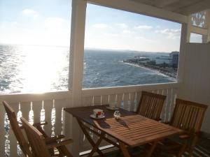 a table and chairs on a porch with a view of the ocean at Fürstenhof in Sassnitz