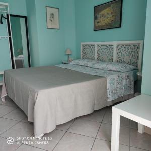 Ce lit se trouve dans un dortoir doté d'un mur bleu. dans l'établissement La casa di Antonia, à Catane