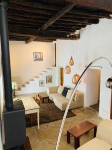 a living room with a fire place and a ladder at Can Quince de Balafia - Turismo de Interior in Sant Llorenç de Balafia