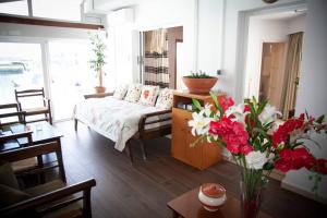 a living room with a couch and a table with flowers at STAVROS amazing apartment in the centre of KOS in Kos Town