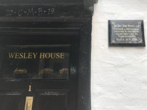 a door to a wesley house with a sign on it at "Wesley House" Historic home in town Centre with Parking in Shrewsbury