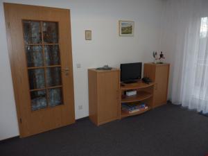 a room with a desk with a computer and a door at Ferienwohnung Cafe`Rotter , Brigitte und Jürgen Rotter in Schellerhau