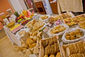 a table filled with lots of different types of food at Hotel Jardin De Iguazu in Puerto Iguazú