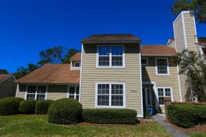 a house with bushes in front of it at Herons' Haven in Charleston