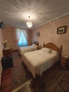 Postel nebo postele na pokoji v ubytování Pension Lorea