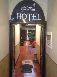 a hotel entrance with a sign over the door at La Posada Cuencana Hotel in Cuenca