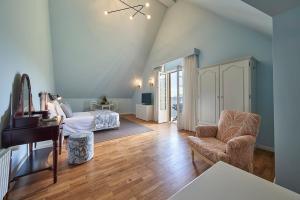 a bedroom with a bed and a chair and a piano at Hotel Quinta Do Furao in Santana