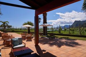 a patio with chairs and umbrellas with a view of the ocean at Hotel Quinta Do Furao in Santana