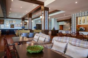 a living room with couches and a table and chairs at Hotel Quinta Do Furao in Santana