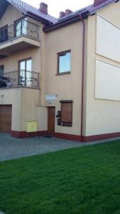 a house with two balconies and a yard at Apartamencik na Doby - Lubin in Lubin