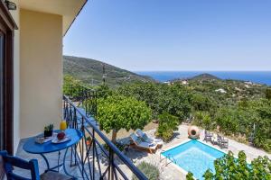 a balcony with a view of a swimming pool at Villa Driades in Skopelos Town