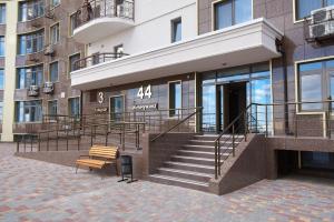 a building with stairs and a bench in front of it at Atmosfera Hotel in Odesa