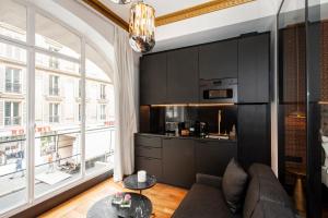 a living room with a couch and a table at LE MARAIS PRESTIGE Luxueux - Cosy - Wifi in Paris