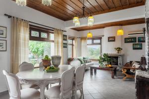 a dining room with a table and chairs at Villa Driades in Skopelos Town