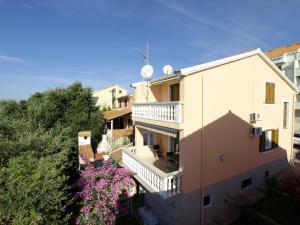 an apartment building with a balcony and purple flowers at Villa Brucker in Kožino