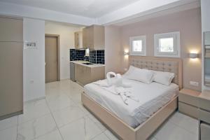 a bedroom with a bed with white shoes on it at Art Studios in Neos Marmaras