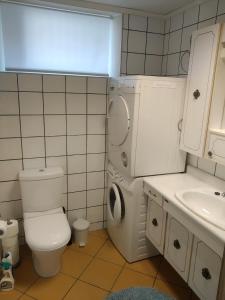 a small bathroom with a toilet and a sink at Koselig to roms leilighet in Vennesla