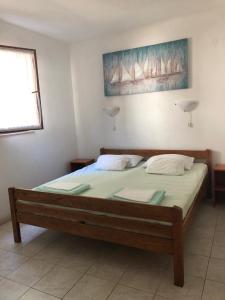 a bedroom with a large bed with two pillows at Apartment Kordić in Sveta Nedelja