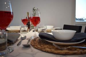 a table with glasses of wine and a bowl on it at Luxury Lavender in Larnaca