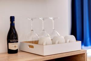 a bottle of wine and wine glasses in a box at SM Vatican Relais B&B in Rome