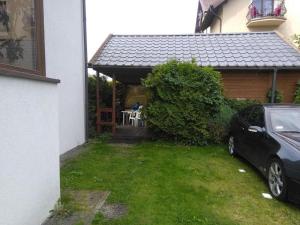 a car parked in front of a house at Domek Muszelka in Karwia