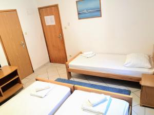 Postel nebo postele na pokoji v ubytování Guesthouse Villa Paškal