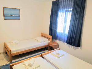 Postel nebo postele na pokoji v ubytování Guesthouse Villa Paškal