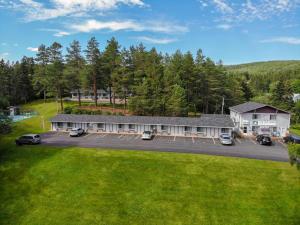 an aerial view of a building with a parking lot at Fair Isle Motel & The Nest in Whycocomagh