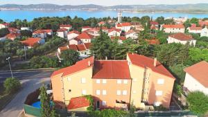 an aerial view of a town with houses and a lake at SOLARIS ANTONELA Modern Apartments with Sea View & Free Private Parking in Sveti Filip i Jakov
