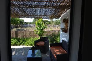 a view of a patio with a chair and a table at Es Barranco in Ferreries