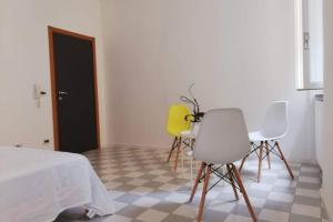 a room with three chairs and a table and a bed at Appartamento nel centro storico in Ancona