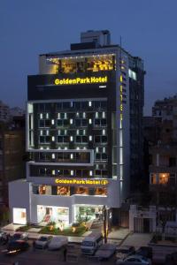 a building with a parking lot in front of it at Golden Park Hotel Cairo, Heliopolis in Cairo