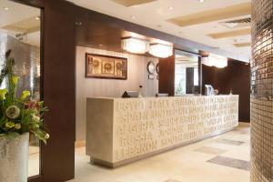 a restaurant with a reception desk in a lobby at Golden Park Hotel Cairo, Heliopolis in Cairo