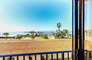 a balcony with a view of a beach and the ocean at Rosarito Beach Hotel in Rosarito