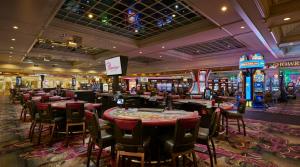 a casino with tables and chairs in a casino at Flamingo Las Vegas Hotel & Casino in Las Vegas
