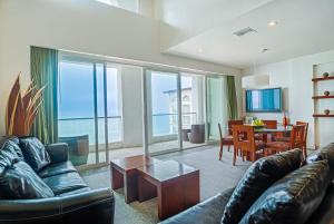 a living room with a couch and a table at Rosarito Beach Hotel in Rosarito