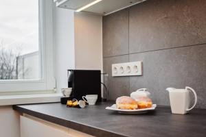 a kitchen counter with a plate of donuts on it at Best INN Poznań Apartament Orzeszkowej in Poznań