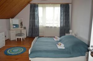 a bedroom with a bed with two towels on it at Dom na Mazurach in Ostróda