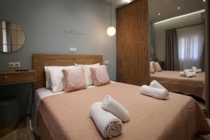a bedroom with two beds with towels on them at Under the Aqueduct boutique house in Kavála