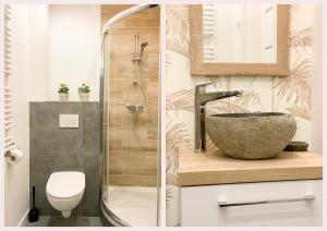 two images of a bathroom with a sink and a shower at Simply Modern Apartment in Toruń