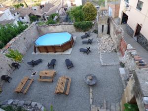 an overhead view of a patio with a pool and tables and chairs at EVA & TRAVEL - El Cor del Montsant in Ulldemolins