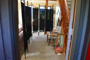 a hallway with black curtains and a table and chairs at Estuary House Reflexology B&B in Courtenay