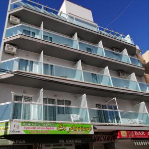 a large white building with blue balconies at Apartamentos Arcadio in El Arenal