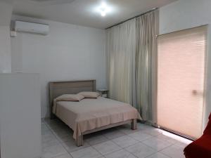 Tempat tidur dalam kamar di Residencial Luz da Manhã II