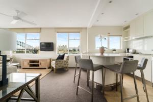 a kitchen and living room with a table and chairs at Harbourside #76 in Sydney