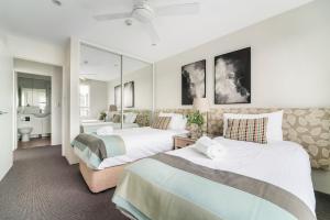 a hotel room with two beds and a bathroom at Harbourside #76 in Sydney