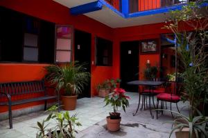 a patio with a bench and a table and plants at HOTEL POSADA DEL CORTEZ in La Paz +5 photos