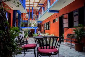 a patio with chairs and a table in a building at HOTEL POSADA DEL CORTEZ in La Paz