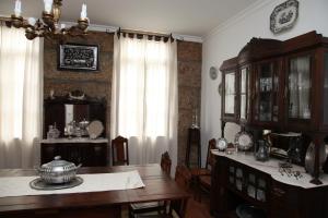 a dining room with a table and a chandelier at Casa Cardoso in São Martinho de Mouros