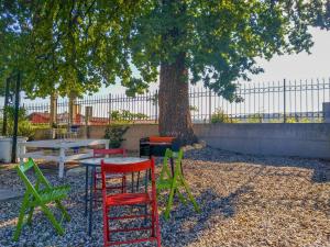 a group of chairs and a table under a tree at Rustico alla Quercetta in Verona